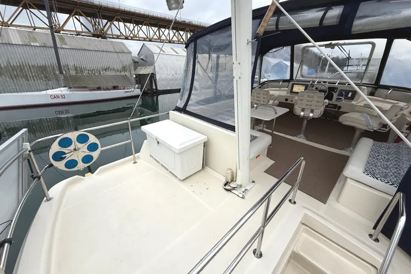 Hula Moon Yacht Photos Pics 2006 Mainship 34 Trawler interior with helm, seating, and marina view.