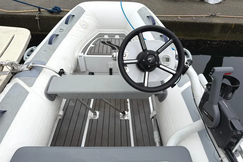 Hula Moon Yacht Photos Pics Interior view of a 2006 Mainship 34 Trawler with steering wheel and controls.