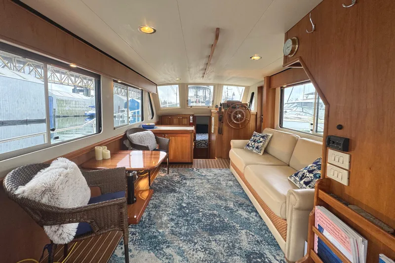Hula Moon Yacht Photos Pics Interior of 2006 Mainship 34 Trawler with cozy seating and nautical decor.