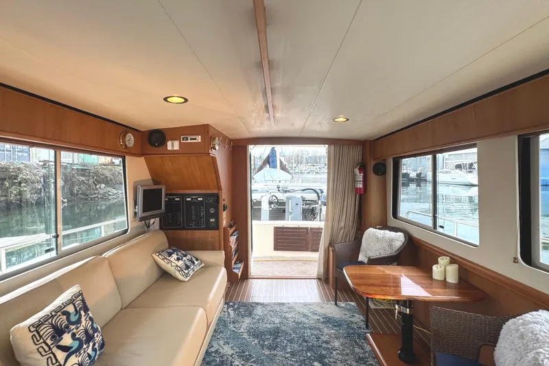 Hula Moon Yacht Photos Pics Interior of 2006 Mainship 34 Trawler with cozy seating and marina view.