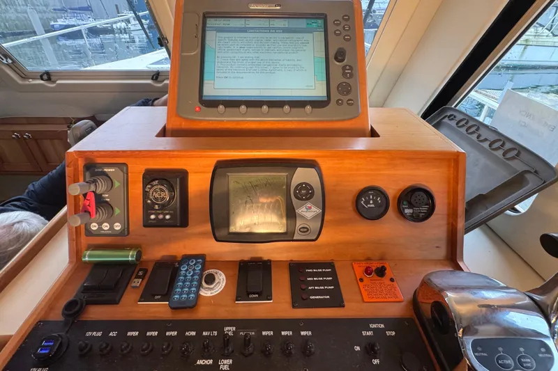 Hula Moon Yacht Photos Pics 2006 Mainship 34 Trawler helm with navigation equipment and control panel.