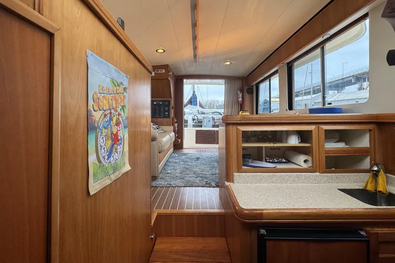 Hula Moon Yacht Photos Pics Interior of 2006 Mainship 34 Trawler with wooden cabinetry and nautical decor.