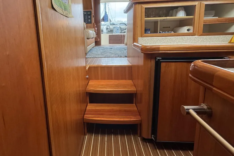 Hula Moon Yacht Photos Pics Interior of 2006 Mainship 34 Trawler with wooden steps and cabinetry.