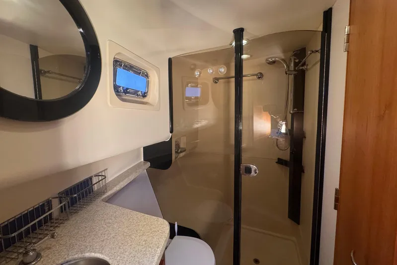 Hula Moon Yacht Photos Pics Bathroom interior of 2006 Mainship 34 Trawler with shower and sink.