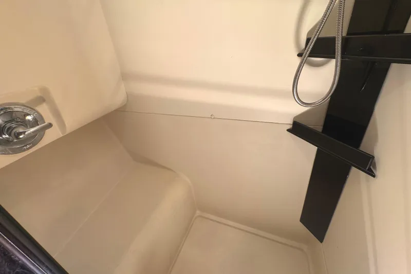 Hula Moon Yacht Photos Pics 2006 Mainship 34 Trawler shower area with modern fixtures and beige interior.