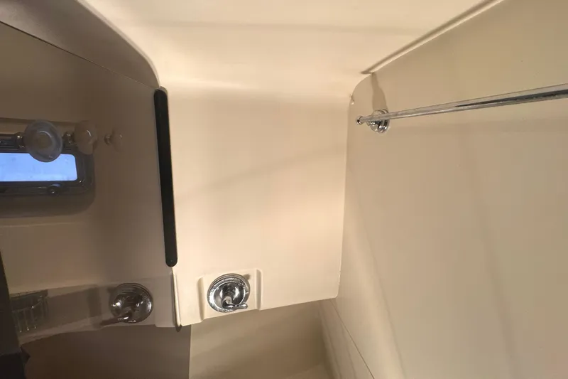 Hula Moon Yacht Photos Pics Interior of 2006 Mainship 34 Trawler, featuring a compact bathroom with a window.