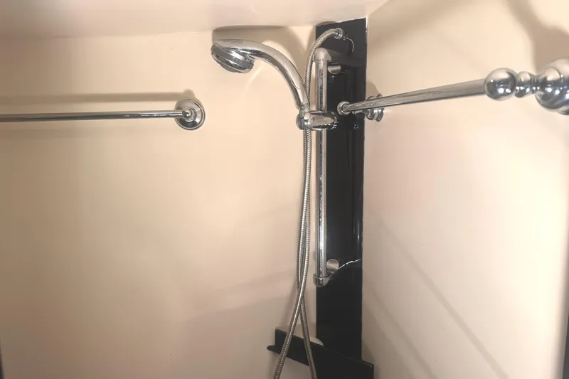 Hula Moon Yacht Photos Pics Shower area in 2006 Mainship 34 Trawler with chrome fixtures and dual towel bars.