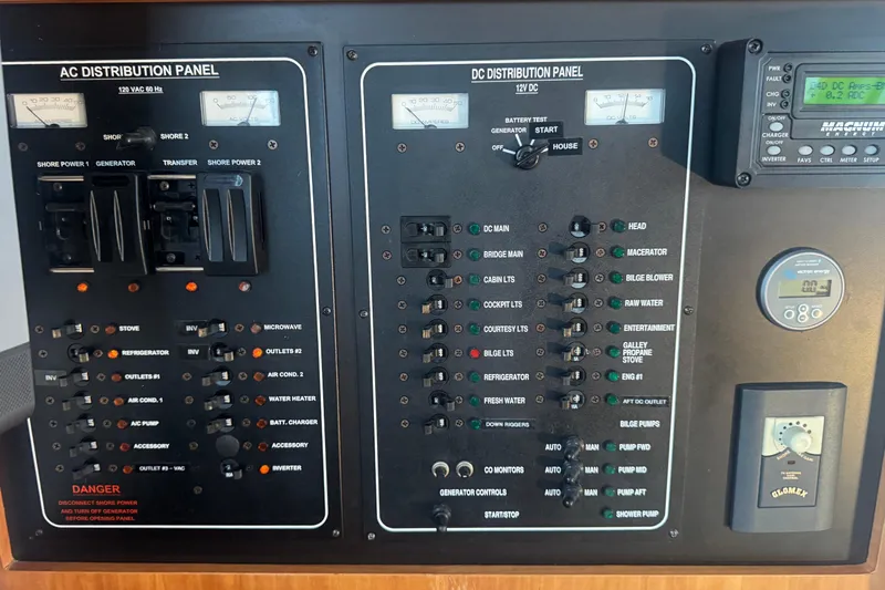 Hula Moon Yacht Photos Pics Electrical control panel on a 2006 Mainship 34 Trawler boat, featuring AC and DC distribution.
