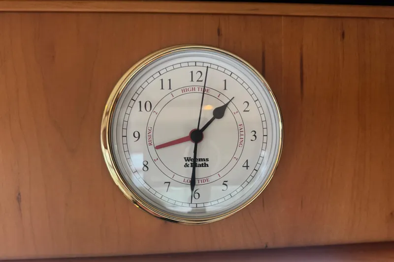 Hula Moon Yacht Photos Pics Weems & Plath tide clock on 2006 Mainship 34 Trawler wooden interior.