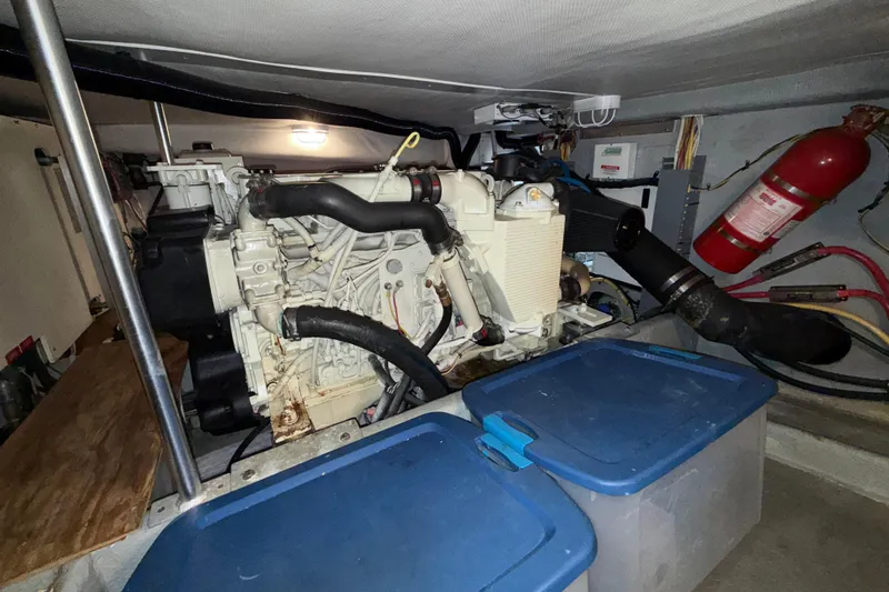 Hula Moon Yacht Photos Pics Engine room of 2006 Mainship 34 Trawler with visible engine and fire extinguisher.
