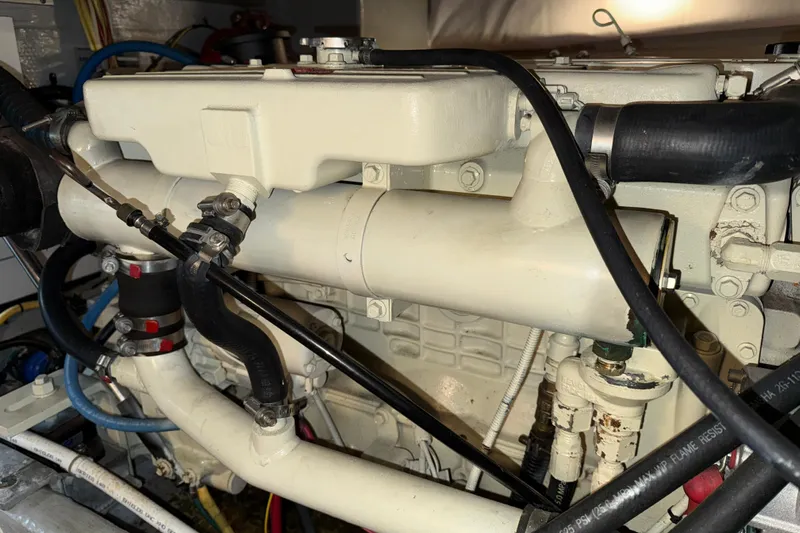 Hula Moon Yacht Photos Pics Engine of a 2006 Mainship 34 Trawler with visible hoses and components.