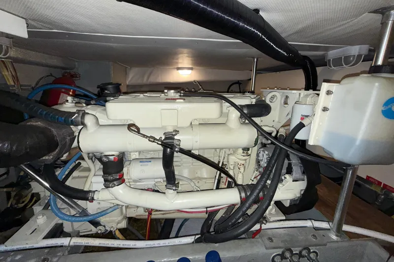 Hula Moon Yacht Photos Pics Engine room of a 2006 Mainship 34 Trawler, showcasing detailed mechanical components.