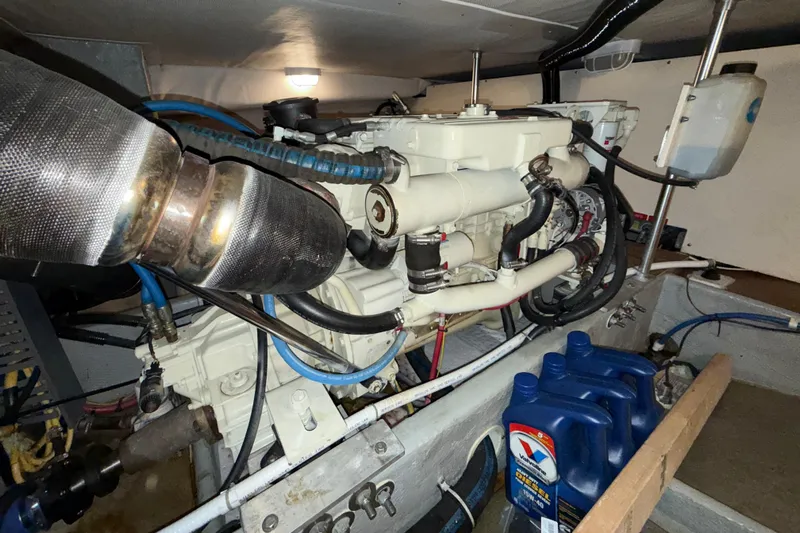 Hula Moon Yacht Photos Pics Engine room of 2006 Mainship 34 Trawler with visible components and oil containers.