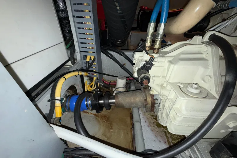 Hula Moon Yacht Photos Pics Engine compartment of a 2006 Mainship 34 Trawler, showcasing mechanical components and wiring.