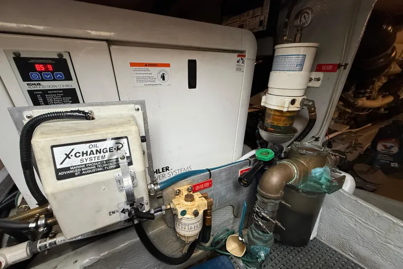 Hula Moon Yacht Photos Pics Engine room of 2006 Mainship 34 Trawler with oil exchange and filtration systems.