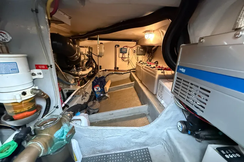 Hula Moon Yacht Photos Pics Engine room of 2006 Mainship 34 Trawler, showcasing equipment and machinery.