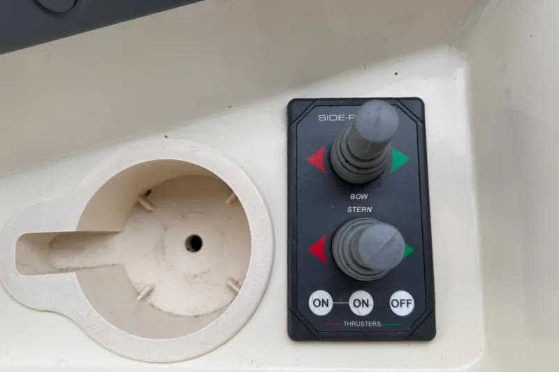 Hula Moon Yacht Photos Pics Control panel of a 2006 Mainship 34 Trawler with bow and stern thruster controls.