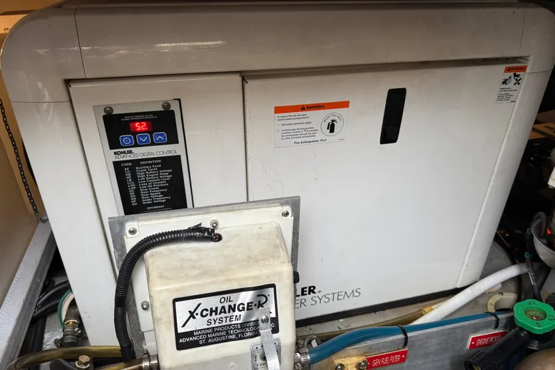 Hula Moon Yacht Photos Pics Engine room of 2006 Mainship 34 Trawler with Kohler generator and oil exchange system.