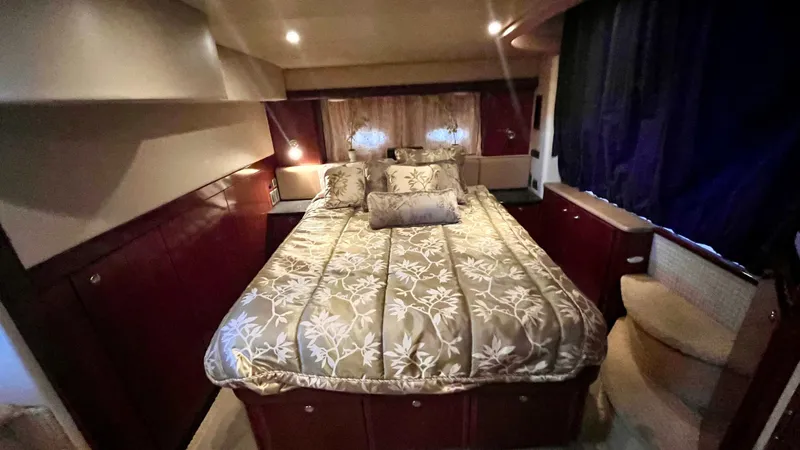  Yacht Photos Pics Luxurious bedroom in a 2008 Meridian 459 Motoryacht with elegant bedding and ambient lighting.