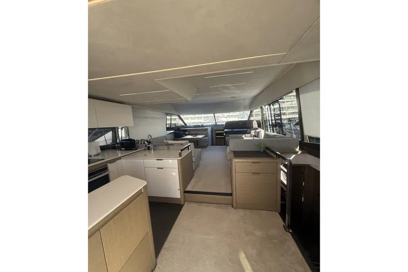  Yacht Photos Pics Luxurious interior of 2022 Prestige 590 yacht with modern kitchen and seating area.