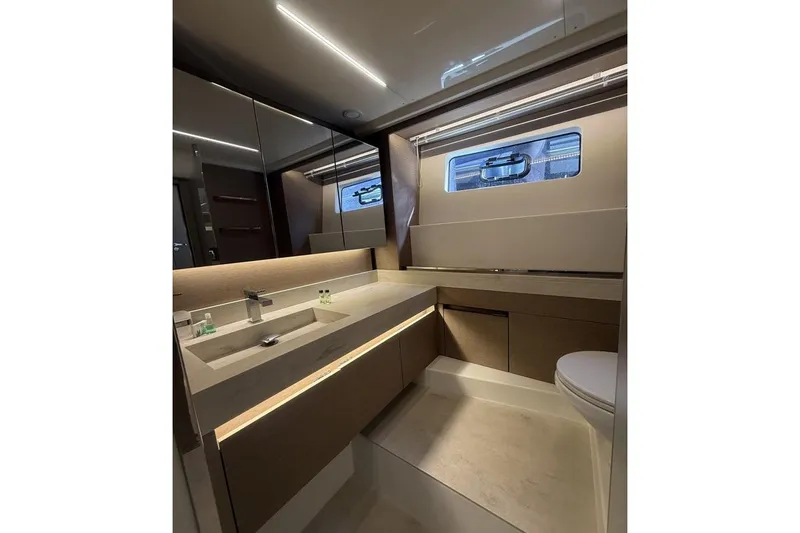  Yacht Photos Pics Luxurious bathroom interior of 2022 Prestige 590 yacht with modern fixtures and lighting.