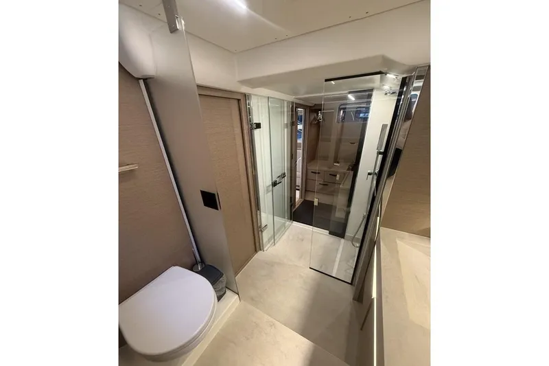  Yacht Photos Pics Luxurious bathroom interior of 2022 Prestige 590 yacht with modern fixtures and glass shower.