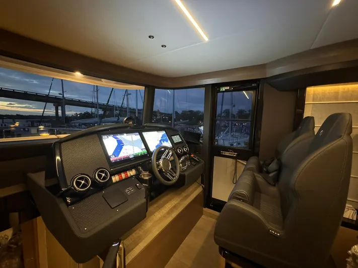  Yacht Photos Pics Helm of 2024 Absolute 58 Navetta yacht with dual navigation screens at sunset.