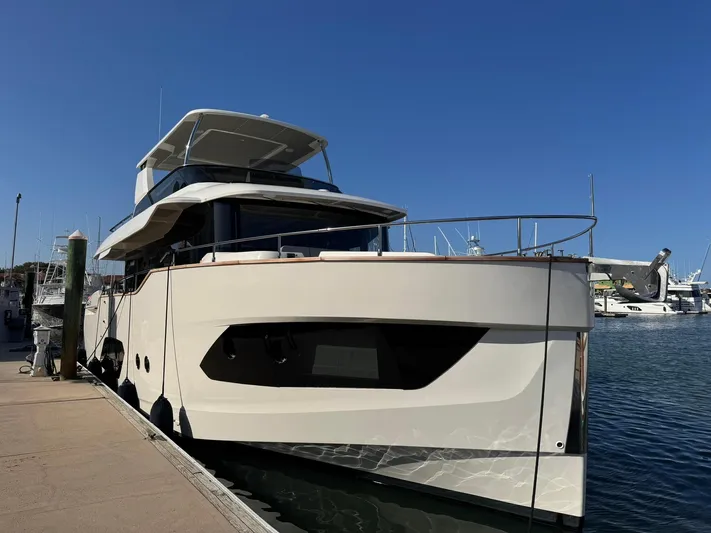  Yacht Photos Pics 2024 Absolute 58 Navetta yacht docked at marina under clear blue sky.