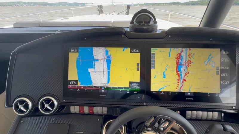  Yacht Photos Pics Cockpit of 2024 Absolute 58 Navetta yacht with dual navigation screens and steering wheel.