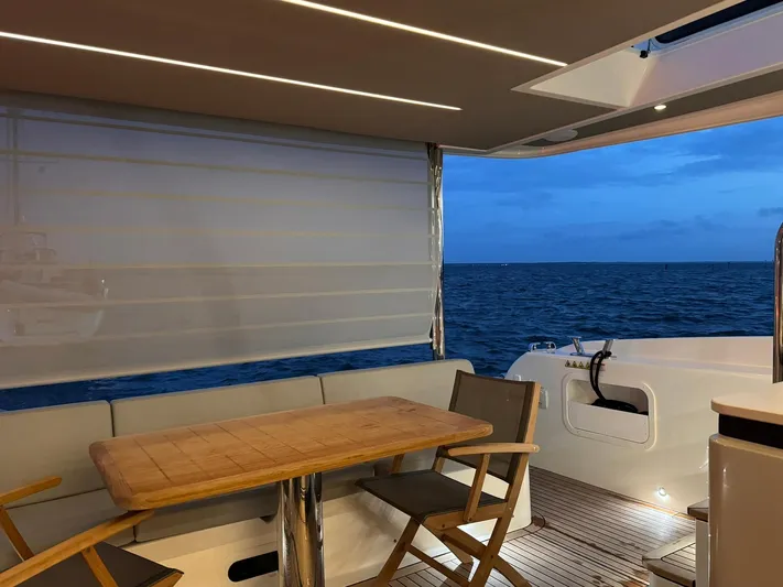  Yacht Photos Pics Luxury yacht Absolute 58 Navetta 2024, featuring elegant outdoor seating with ocean view.