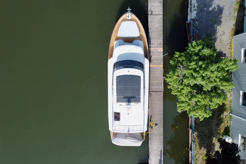  Yacht Photos Pics Aerial view of 2024 Absolute 58 Navetta yacht docked beside a wooden pier.