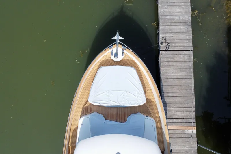  Yacht Photos Pics Aerial view of 2024 Absolute 58 Navetta yacht docked beside a wooden pier.