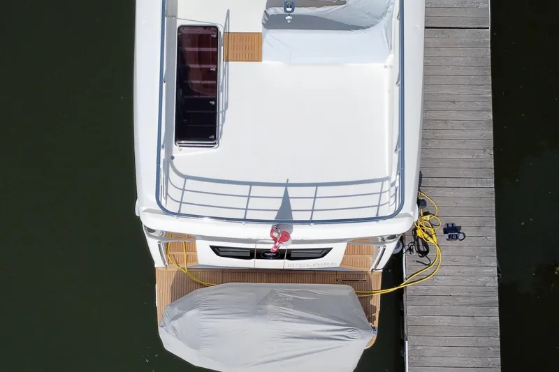  Yacht Photos Pics Overhead view of 2024 Absolute 58 Navetta yacht docked, showcasing deck and covered equipment.