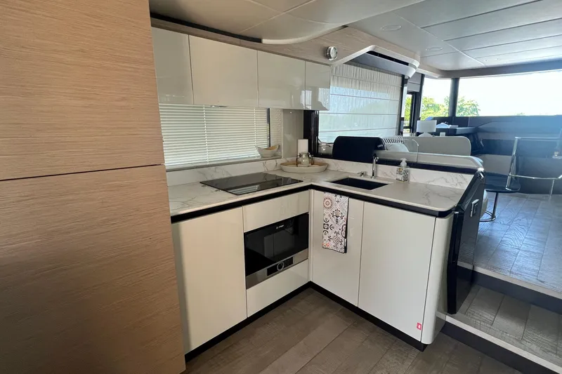  Yacht Photos Pics Modern kitchen in 2024 Absolute 58 Navetta yacht with sleek white cabinetry and appliances.