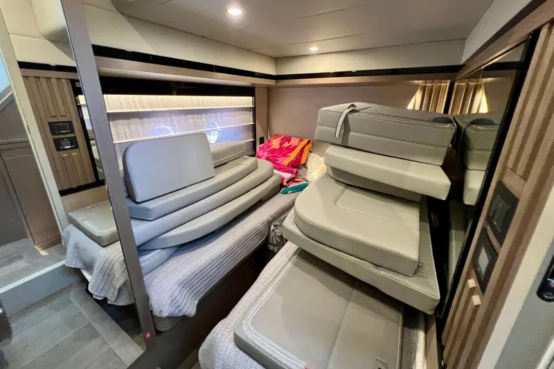  Yacht Photos Pics Interior of 2024 Absolute 58 Navetta yacht with stacked cushions on a bed.
