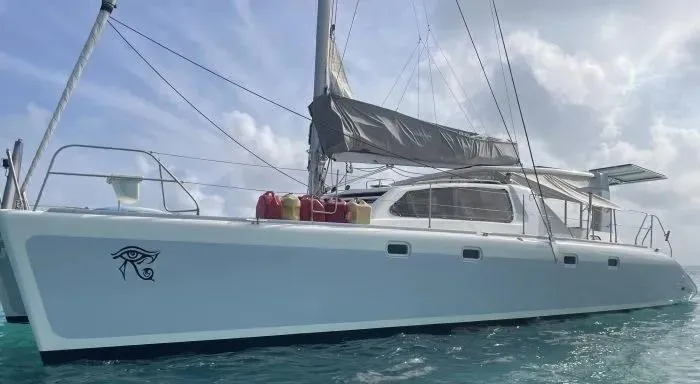 Sv Althea Yacht Photos Pics Leopard 45/47 catamaran from 2000 sailing on clear blue waters.