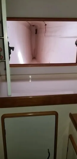 Sv Althea Yacht Photos Pics Interior of a 2000 Leopard 45/47 yacht with wooden trim and storage space.