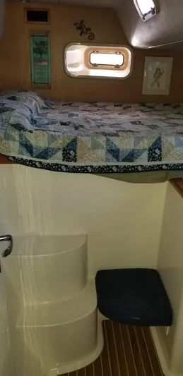 Sv Althea Yacht Photos Pics Interior of 2000 Leopard 45/47 yacht with cozy bed and compact bathroom.