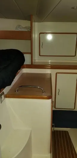 Sv Althea Yacht Photos Pics Interior of 2000 Leopard 45/47 yacht with wooden cabinets and seating area.