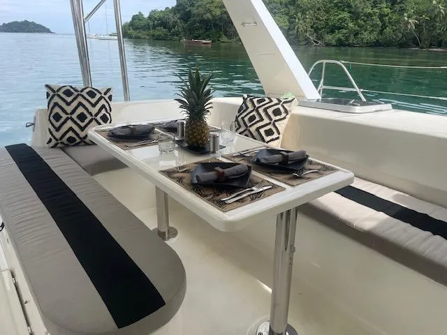 Sv Althea Yacht Photos Pics Luxurious Leopard 45/47 yacht dining area with elegant table setting and scenic water view.