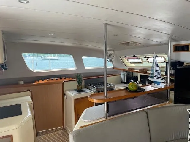 Sv Althea Yacht Photos Pics Interior of 2000 Leopard 45/47 yacht with modern kitchen and seating area.
