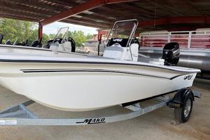 2026 Mako Pro Skiff 15 CC boat on trailer under shelter.