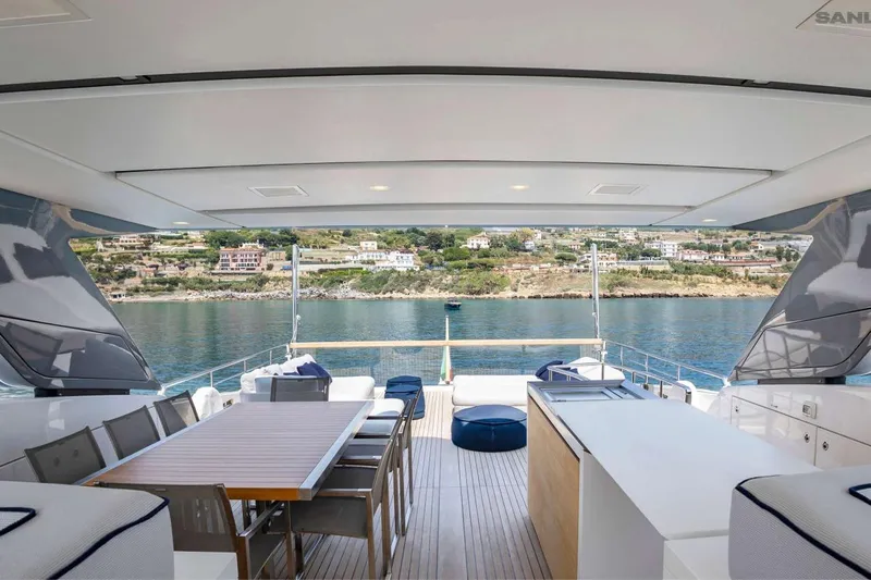 Aman - Sanlorenzo Sl96 Yacht Photos Pics Luxurious 2016 Sanlorenzo SL96 yacht deck with dining area, overlooking scenic coastal view.
