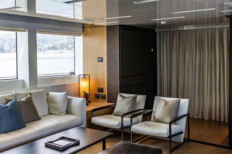 Aman - Sanlorenzo Sl96 Yacht Photos Pics Luxurious interior of 2016 Sanlorenzo SL96 yacht with modern seating and scenic window view.