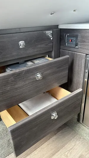  Yacht Photos Pics 2022 Formula 350 CBR interior with open wooden drawers and control panel.