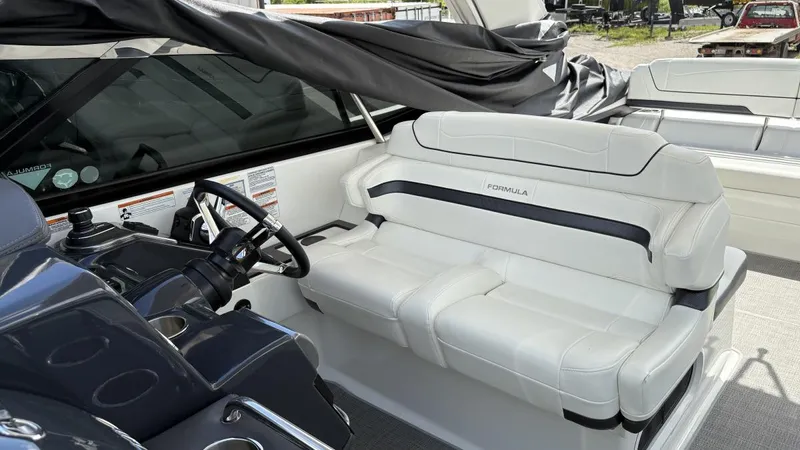  Yacht Photos Pics 2022 Formula 350 CBR boat interior with white seating and steering console.