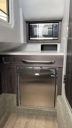  Yacht Photos Pics Interior of 2022 Formula 350 CBR boat with microwave and stainless steel fridge.