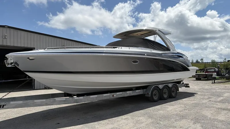  Yacht Photos Pics 2022 Formula 350 CBR boat on trailer, parked outdoors under a partly cloudy sky.