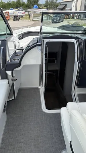  Yacht Photos Pics 2022 Formula 350 CBR boat interior with open cabin door, showcasing seating and cup holders.