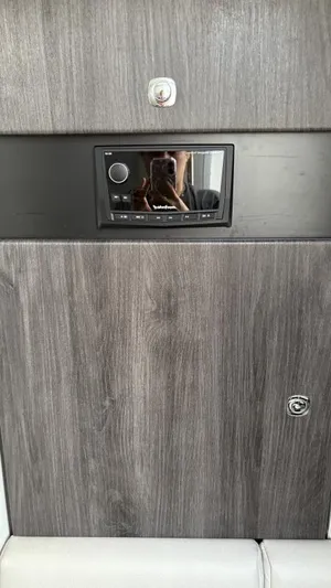  Yacht Photos Pics 2022 Formula 350 CBR interior with wood paneling and built-in audio system.